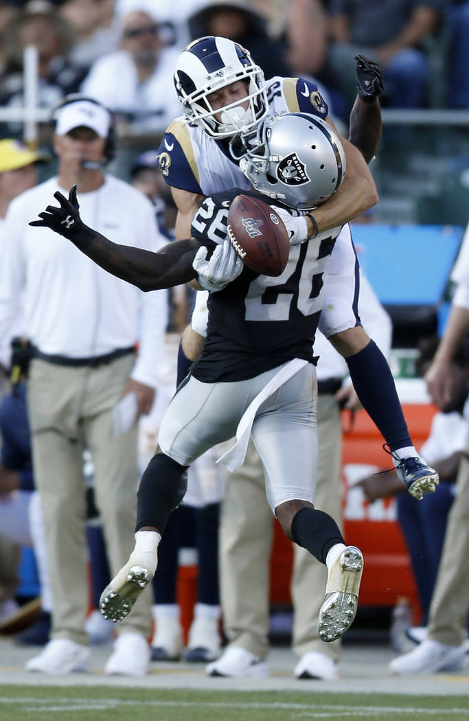 Oakland Raiders' Nevin Lawson (26) breaks up a pass intended for Los Angeles Rams' Alex Bachman ...
