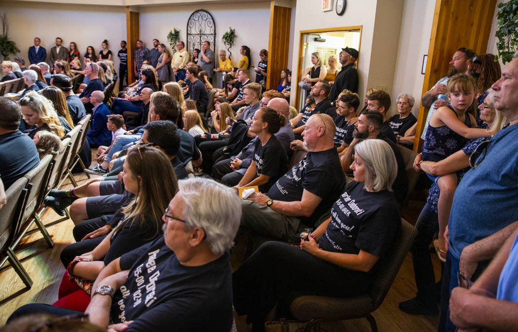 Family members and friends fill the chapel and beyond during the funeral service for Harlee Deb ...