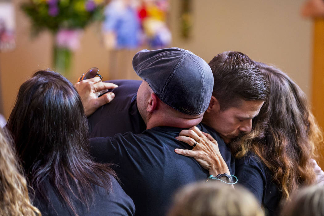 Harlee Deborski's father Jason Deborski, center, and stepmother Amanda Deborski, right, embrace ...