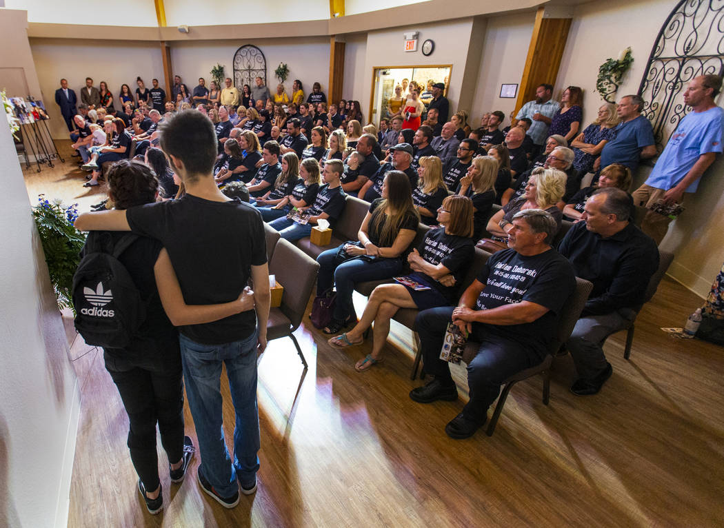 Family members and friends fill the chapel and beyond during the funeral service for Harlee Deb ...