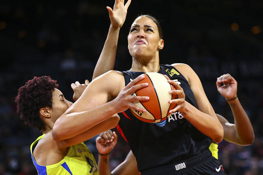 Las Vegas Aces' Liz Cambage drives to the basket against Dallas Wings' Isabelle Harrison during ...