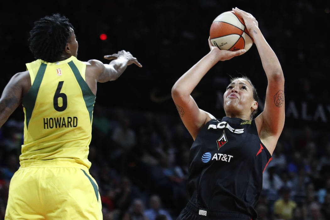 Las Vegas Aces' Liz Cambage shoots around Seattle Storm's Natasha Howard during the first half ...