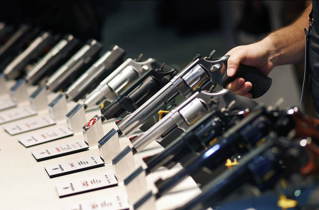 Handguns are displayed at the Smith & Wesson booth at the Shooting, Hunting and Outdoor Trade S ...