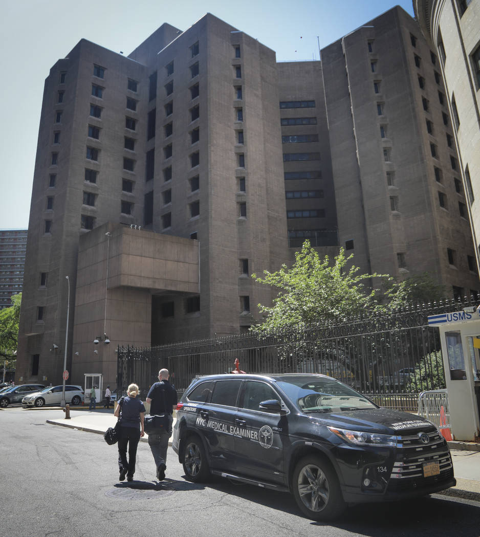 New York City medical examiner personnel leave their vehicle and walk to the Manhattan Correcti ...