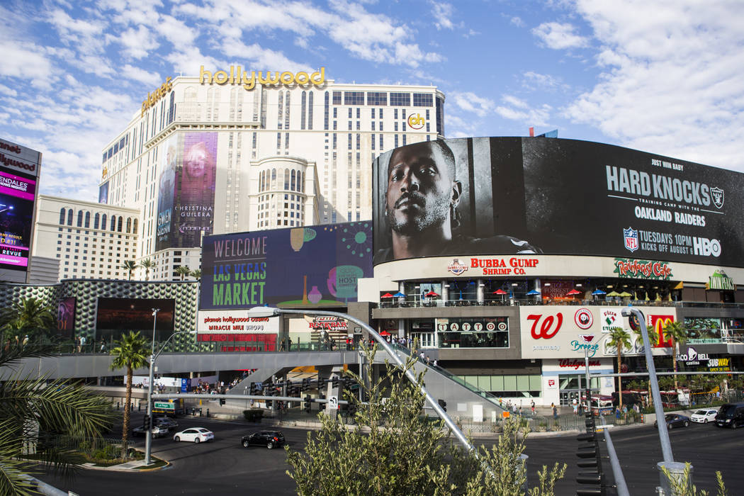 A digital billboard displays Oakland Raiders' Antonio Brown in an advertisement for the upcomin ...