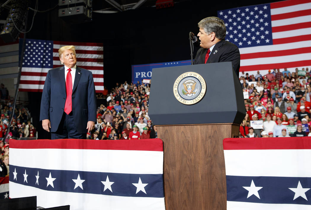 President Donald Trump listens Fox News' Sean Hannity. (AP Photo/Carolyn Kaster)