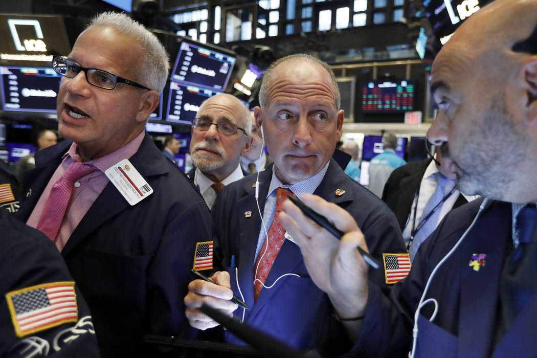 Michael Urkonis, second from right, works with fellow traders on the floor of the New York Stoc ...