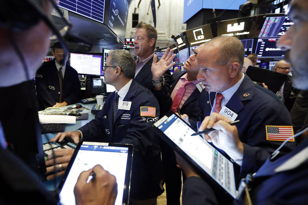 Specialist Patrick Murphy, background center, works with traders on the floor of the New York S ...