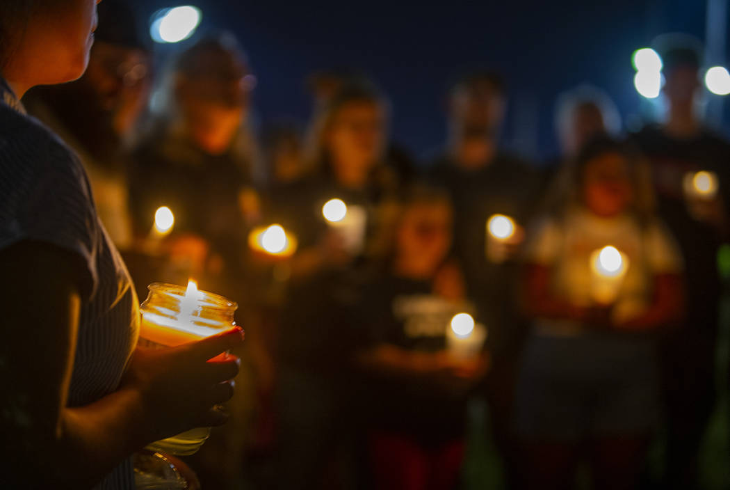 A silent prayer is said during a candlelight vigil for Harlee Deborski and Timothy Bailey at De ...