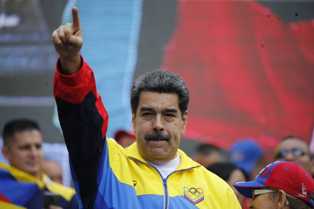 Venezuela's President Nicolas Maduro and first lady Cilia Flores, right, lead a rally condemnin ...