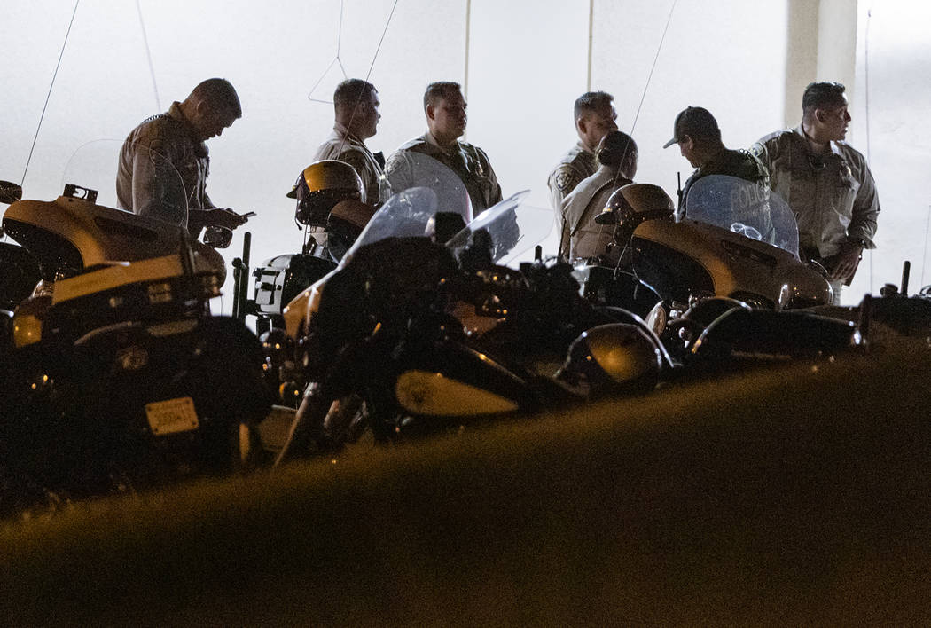 California Highway Patrol officers stage outside an emergency room entrance, late Monday, Aug. ...