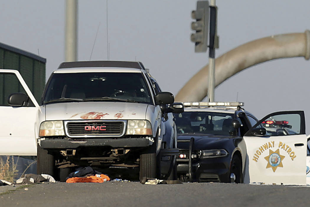 Authorities investigate the scene on the Eastridge Avenue overpass over Interstate 215, where a ...