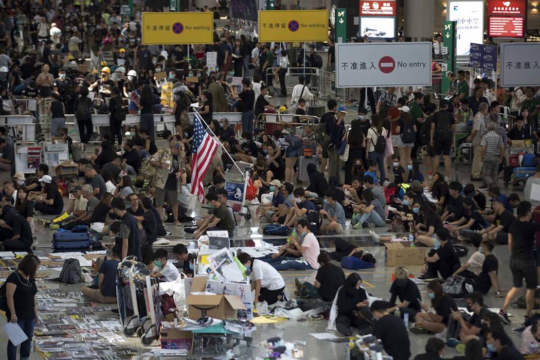 Protesters stage a sit-in rally at the arrival hall of the Hong Kong International Airport in H ...