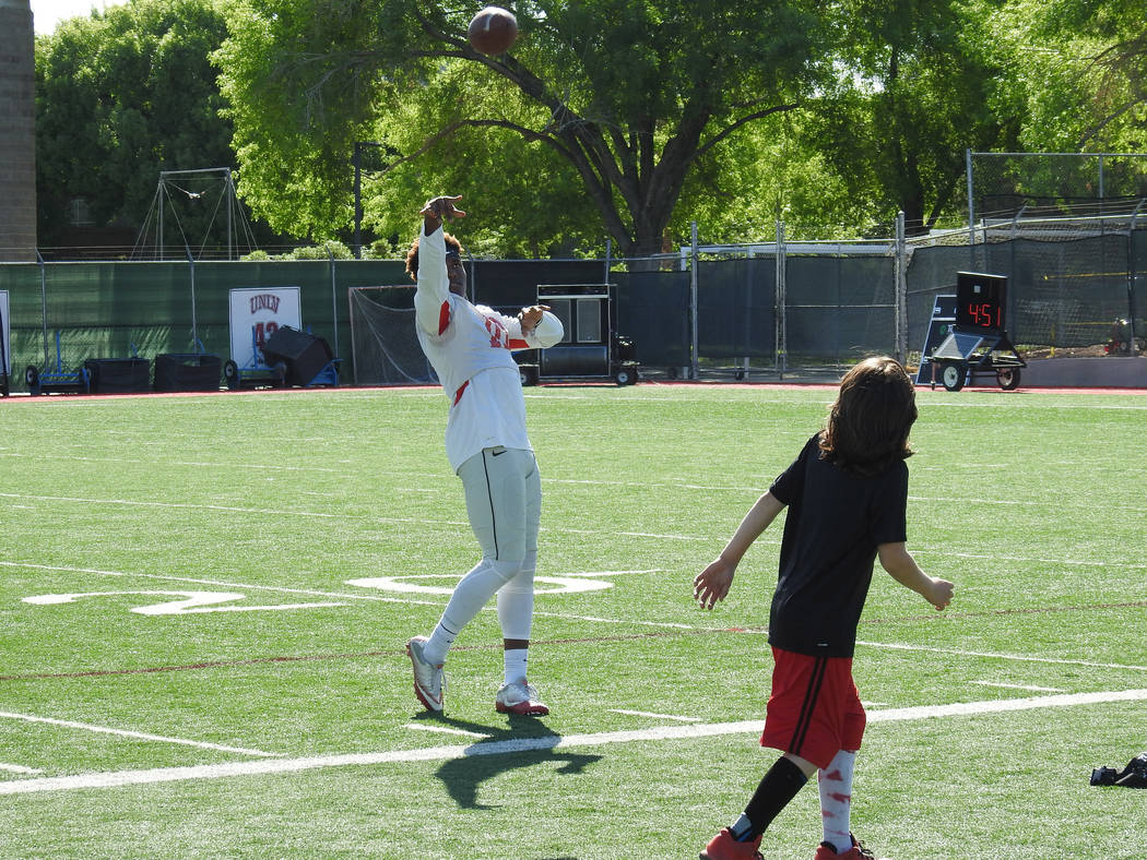 UNLV wide receiver Darren Woods Jr. plays catch with Thaddeus Thatcher, who signed had a ceremo ...