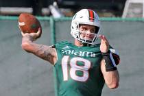 Miami quarterback Tate Martell (18) throws the ball during NCAA college football practice in Co ...