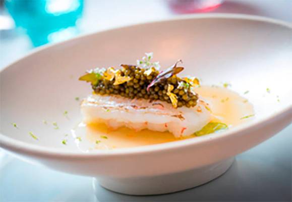 Langoustine topped with Osetra caviar and gold leaf. (Guy Savoy)