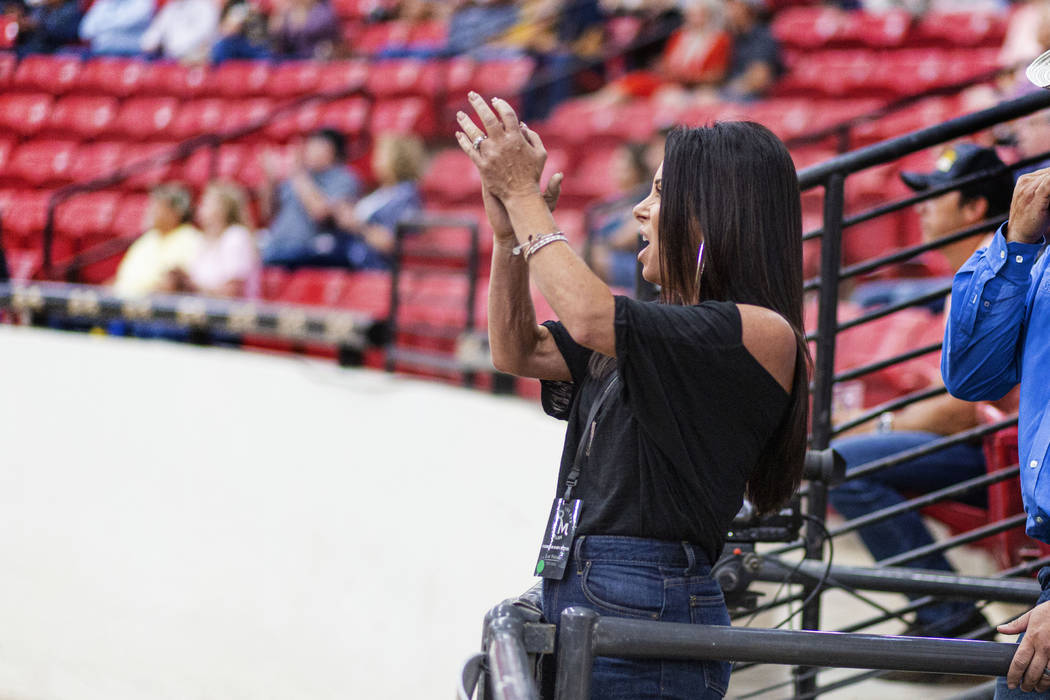 Karen Mills cheers on her husband reining expert Matt Mills at the South Point Arena in Las Veg ...