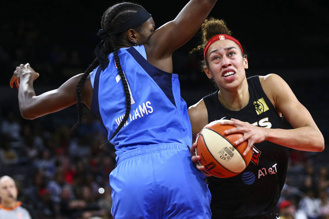 Las Vegas Aces' Dearica Hamby moves the ball around Atlanta Dream's Elizabeth Williams (1) duri ...