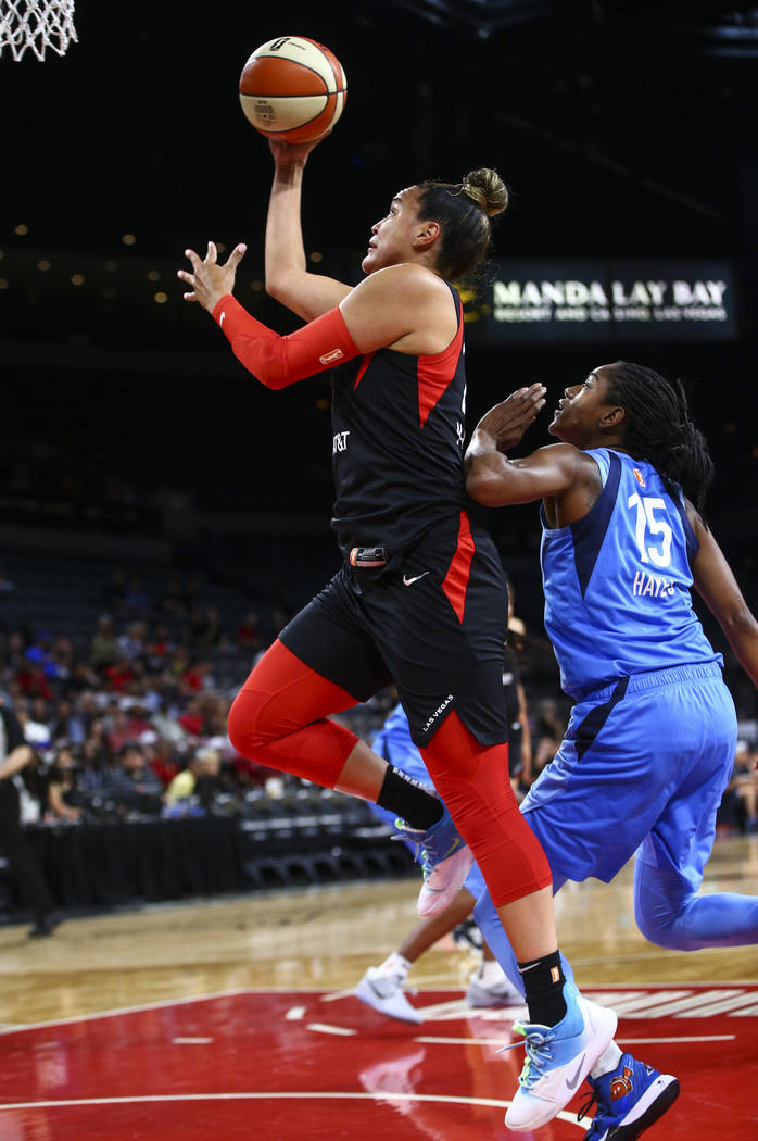 Las Vegas Aces' Kayla McBride goes to the basket past Atlanta Dream's Tiffany Hayes (15) during ...