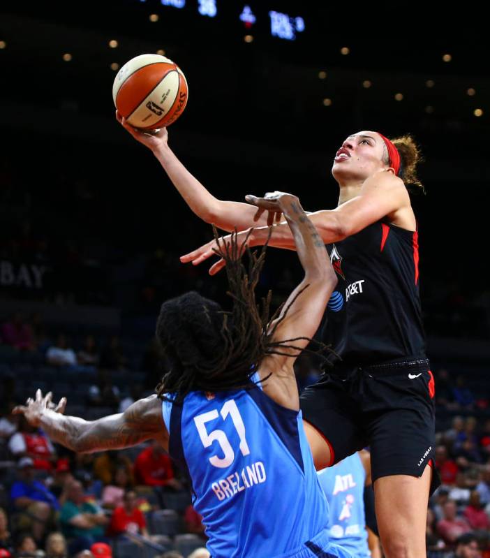 Las Vegas Aces' Dearica Hamby goes to the basket against Atlanta Dream's Jessica Breland (51) d ...