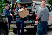 Erie Bureau of Police Det. Dave Walker, left, and Matthew Regentin, center, a fire investigator ...