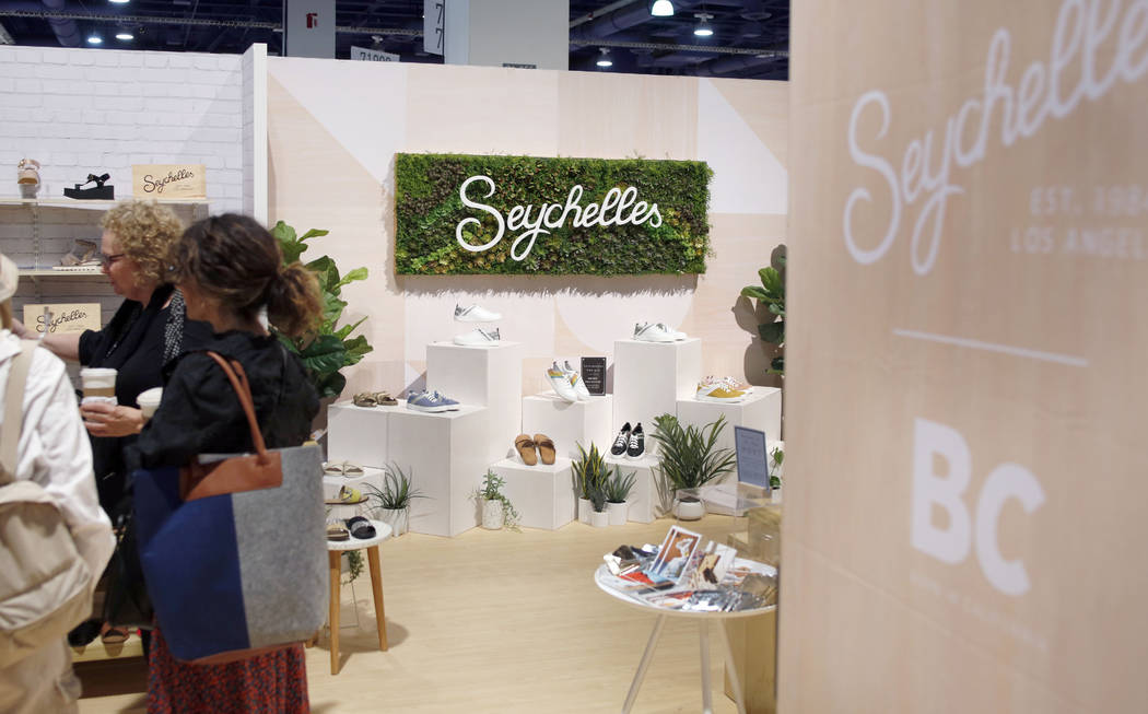 Individuals visit the Seychelles exhibit during the second day of the MAGIC trade show at the L ...