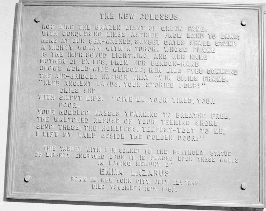 FILE- In this circa 1950 photo shows a bronze plaque of the poem by Poet Emma Lazurus on Statue ...