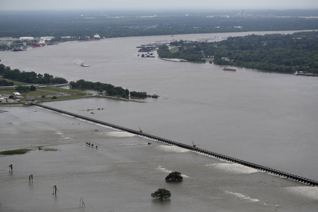 File - In this May 10, 2019 file photo, workers open bays of the Bonnet Carre Spillway, to dive ...