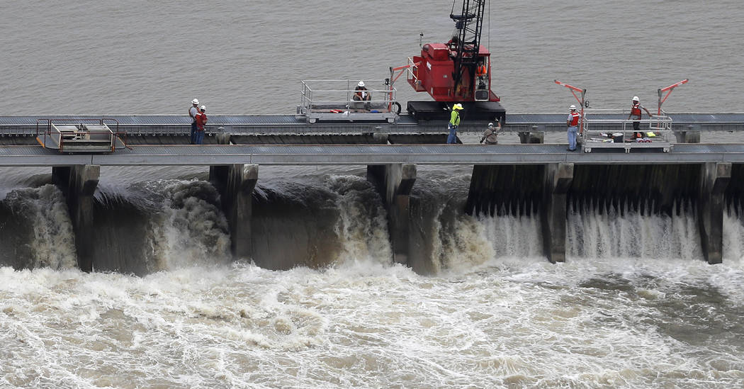 File - In this May 10, 2019, file photo, workers open bays of the Bonnet Carre Spillway, to div ...