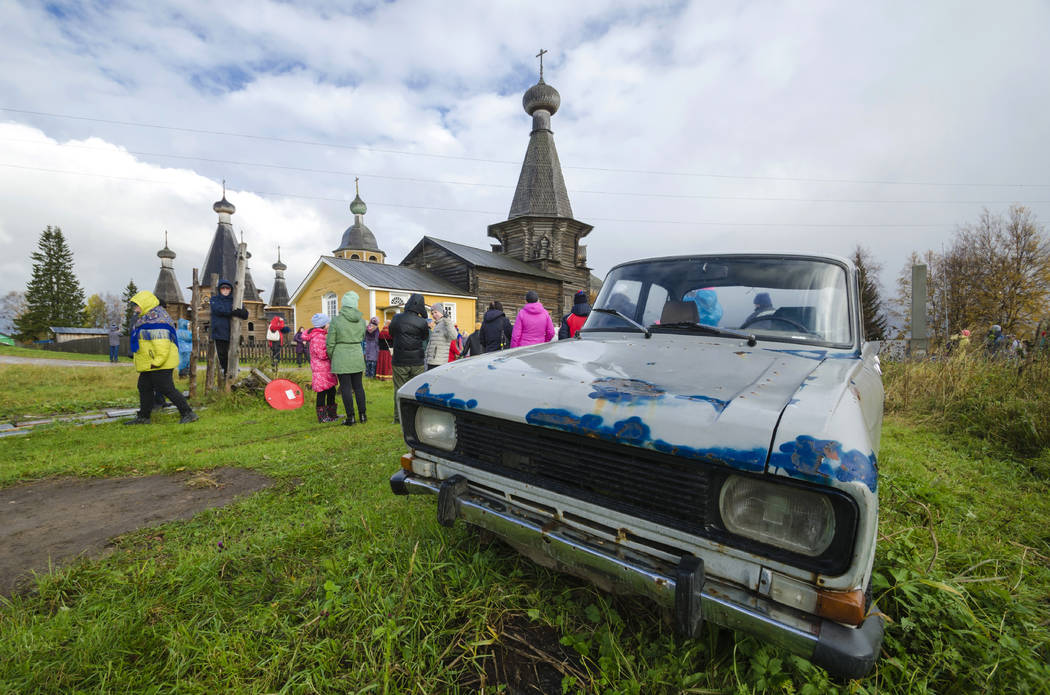 In this photo taken on Oct. 7, 2018, people walk the street with the 18th century Trinity Churc ...