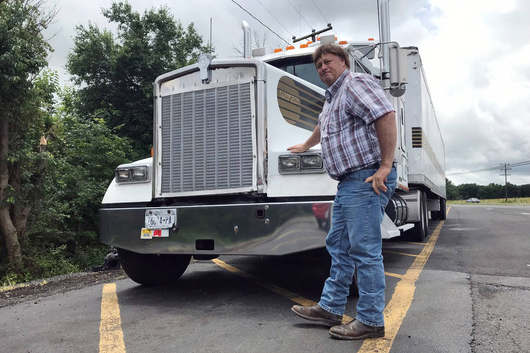 In this June 13, 2019 photo, truck driver Terry Button poses with his truck during at stop in O ...