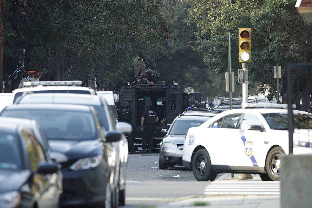 A massive police presence is set up outside a house as they investigate an active shooting situ ...