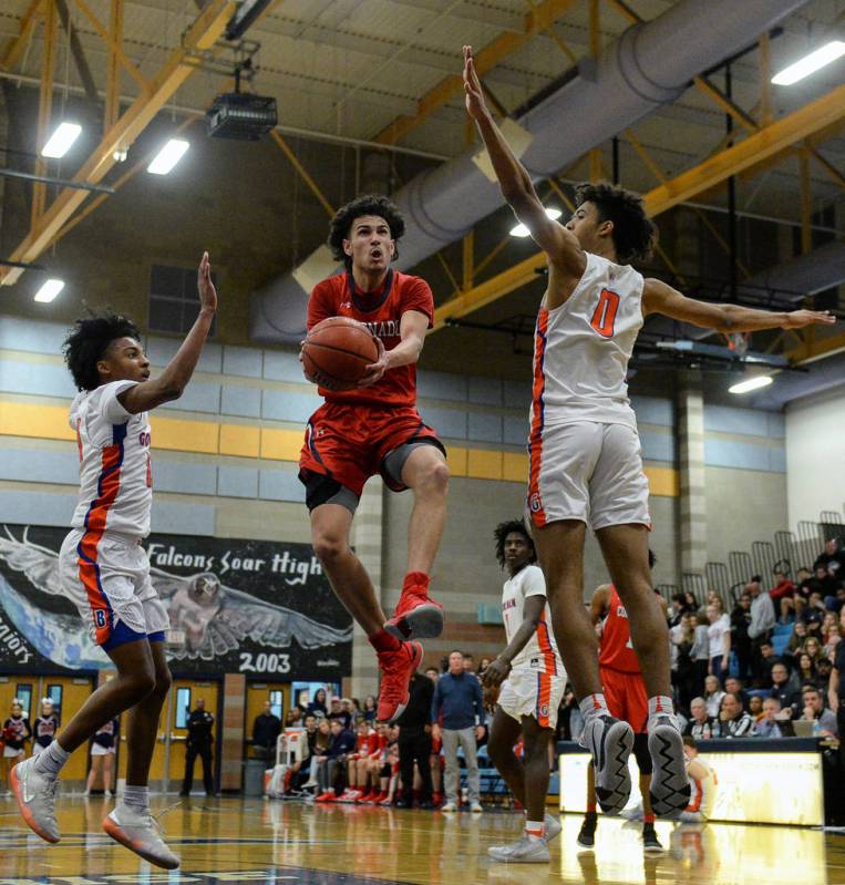 Coronado's Richard Isaacs (2) jumps up to take a shot while being guarded by Bishop Gorman's Za ...