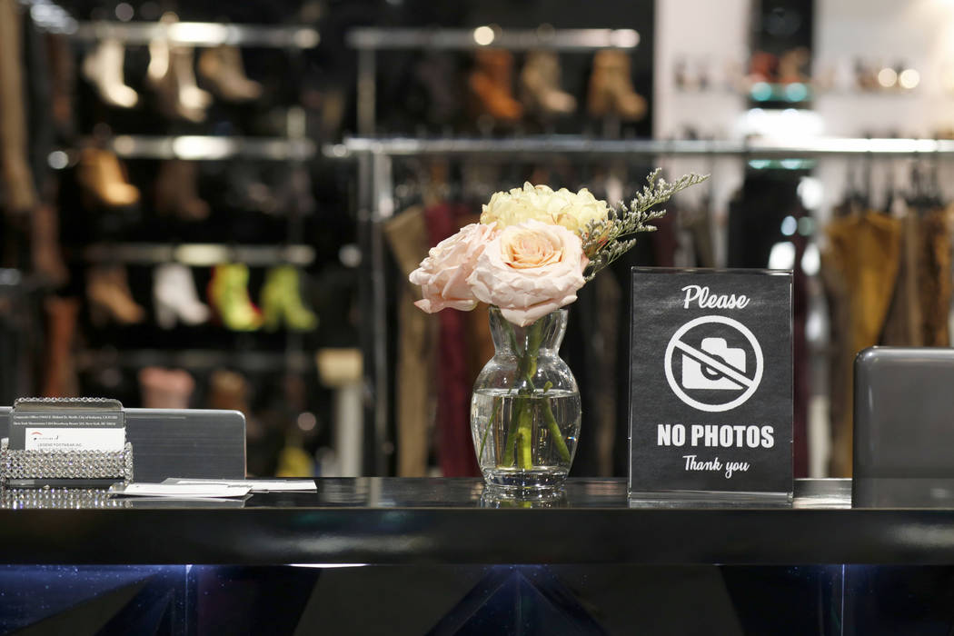 A sign prohibits photography of Legend Footwear Inc.'s exhibit and products on the Fast Fashion ...