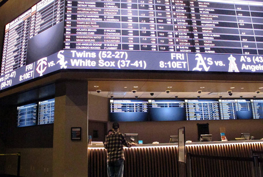 A customer ponders the odds at the new sportbook at Bally's casino in Atlantic City, N.J., in J ...