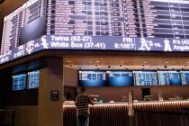 A customer ponders the odds at the new sportbook at Bally's casino in Atlantic City, N.J., in J ...