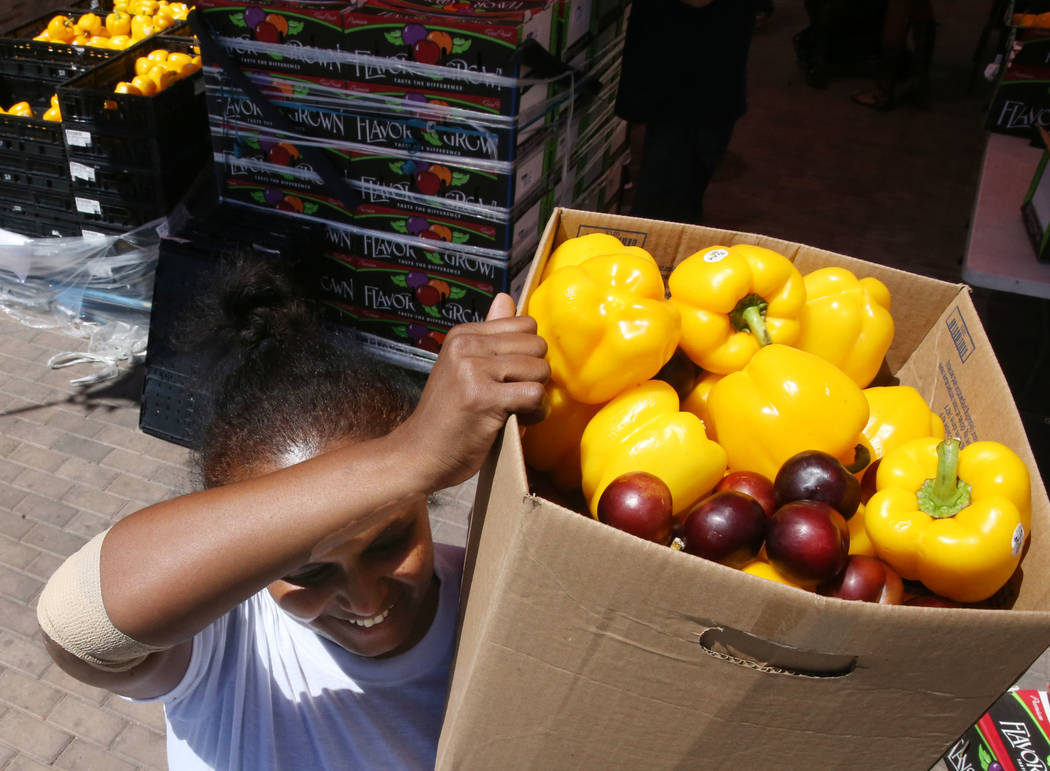 Zenebech Beyene picks up food during a food bank distribution at Veterans Village in downtown L ...