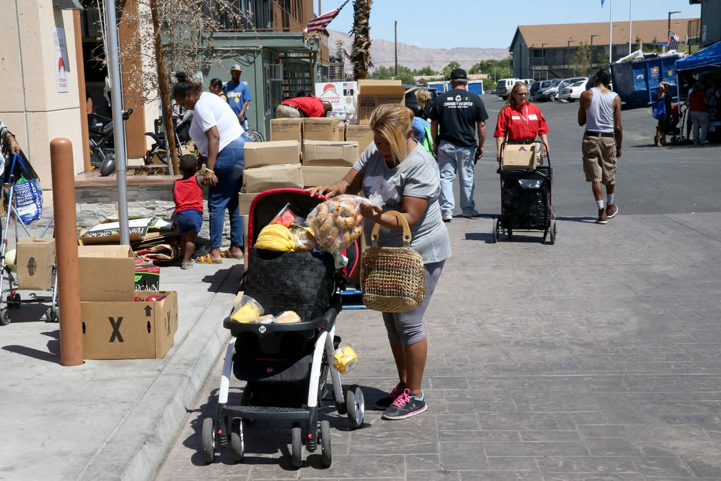 Carina Lopez picks up food during a food bank distribution at Veterans Village in downtown Las ...