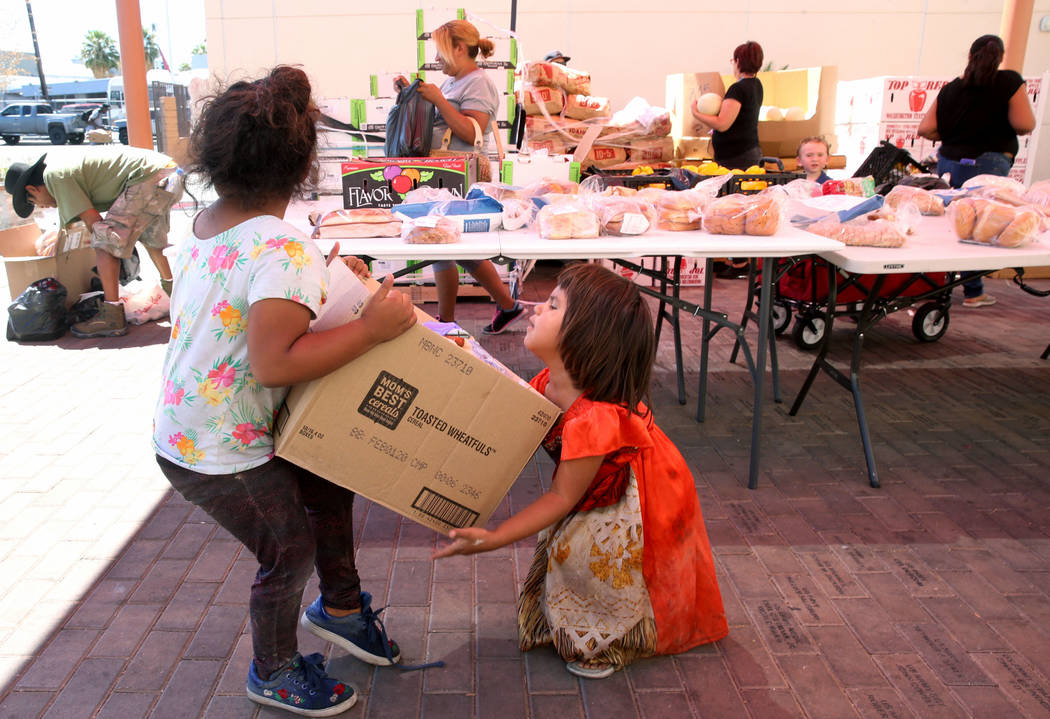 Michelle Morales, 5, left, her sister, Briyit Morales, 3, and their mother, Carina Lopez, rear, ...