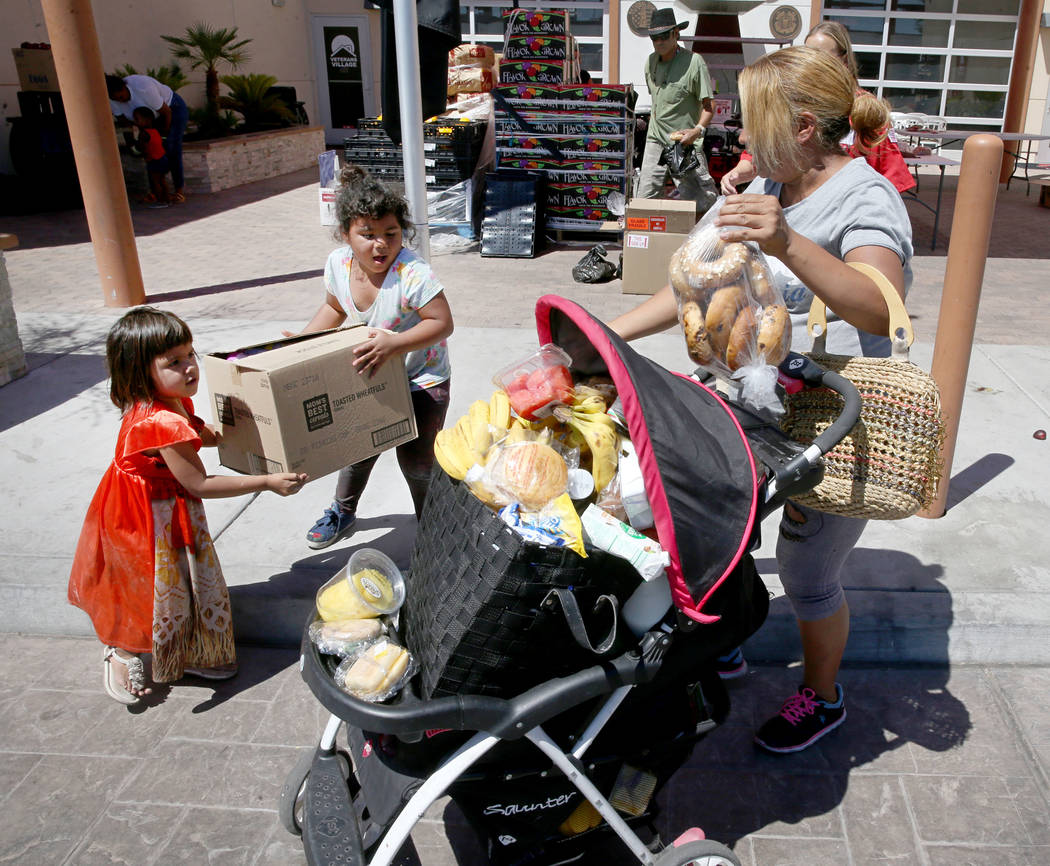 Briyit Morales, 3, left, her sister, Michelle Morales, 5, and their mother, Carina Lopez, pick ...