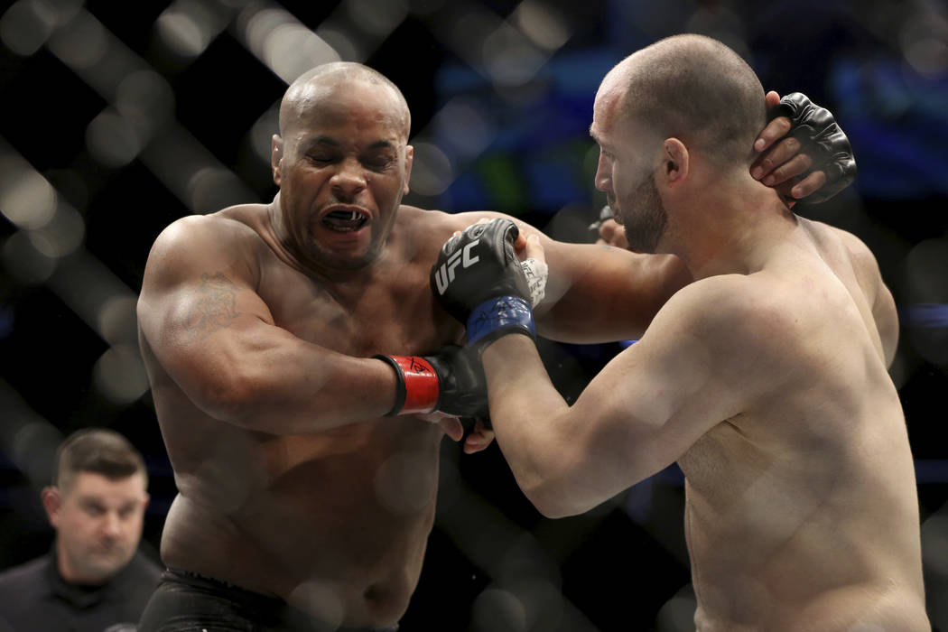 Daniel Cormier, left, exchanges blows with Volkan Oezdemir during a light-heavyweight champions ...