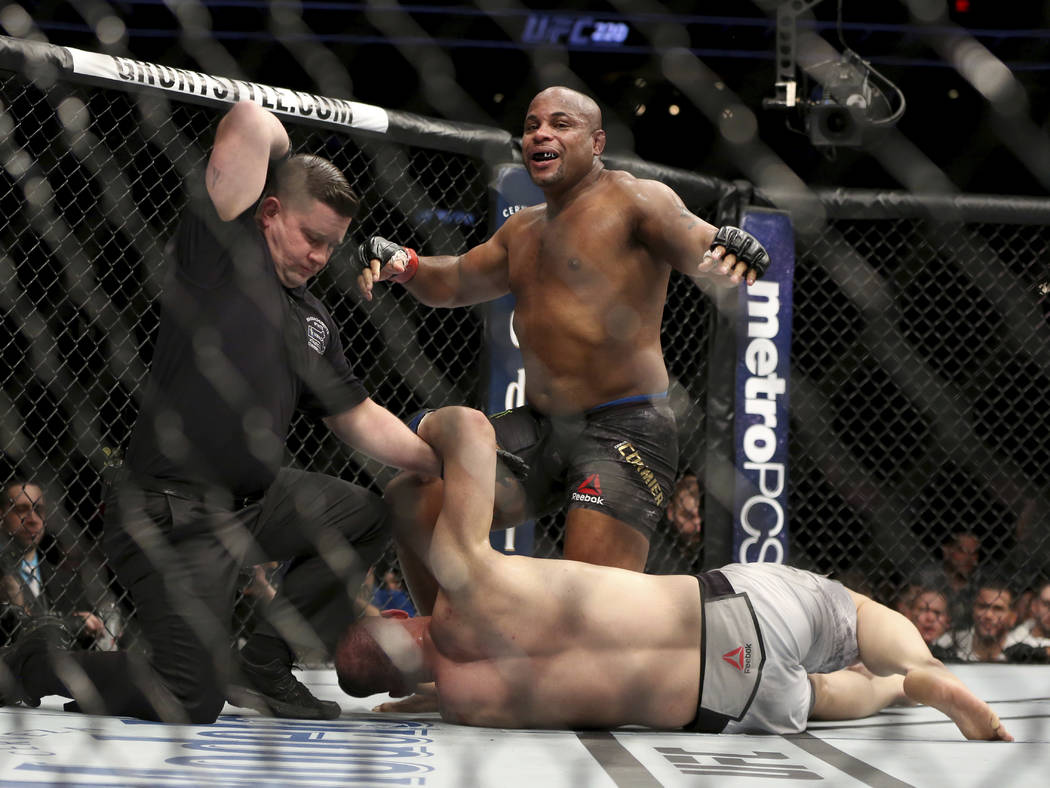 Daniel Cormier celebrates as the referee stops his light heavyweight mixed martial arts bout ag ...