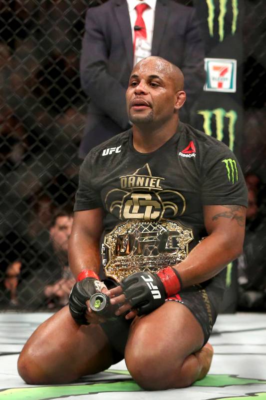 Daniel Cormier celebrates a win over Volkan Oezdemir after a light-heavyweight championship mix ...