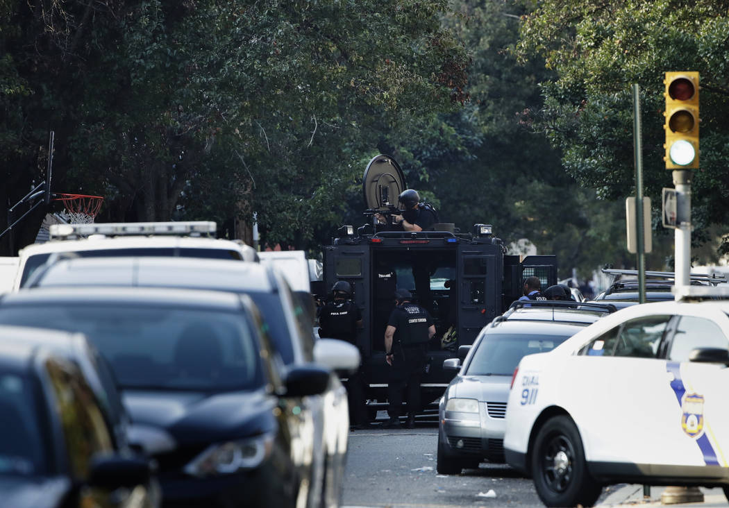 A massive police presence is set up outside a house as they investigate an active shooting situ ...