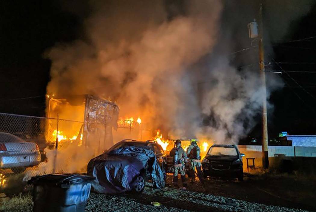 A shed and vehicles burn at B&B Auto Sales, 3800 Vegas Drive, early Thursday morning, Aug. 15, ...