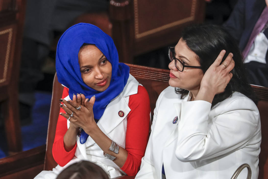 Rep. Ilhan Omar, D-Minn., left, joined by Rep. Rashida Tlaib, D-Mich., listen to President Dona ...