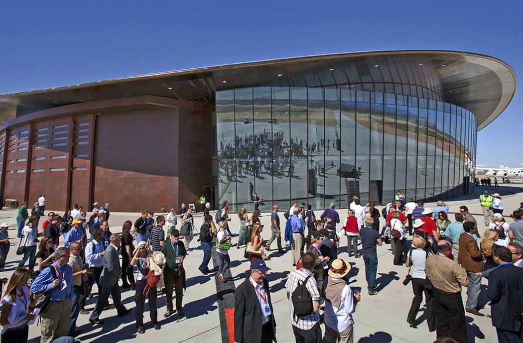 In a Oct. 17, 2011, file photo, guests stand outside the new Spaceport America hangar in Upham, ...