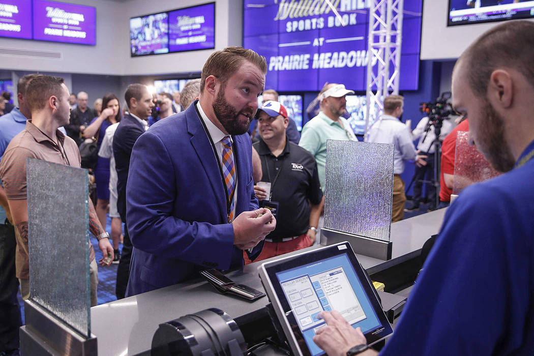 Jake Highfill, a former member of the Iowa House of Representatives, places a bet at Prairie Me ...