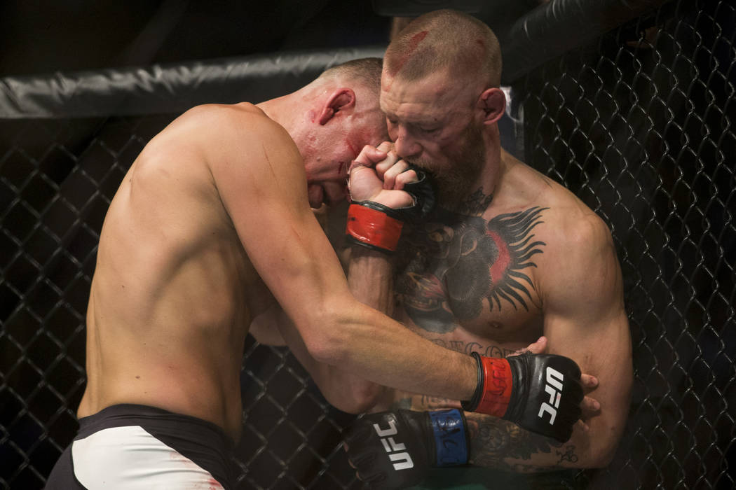 Nate Diaz, left, battles against Conor McGregor in the welterweight bout during UFC 202 at T-Mo ...