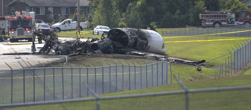 The burned remains of a plane that was carrying NASCAR television analyst and former driver Dal ...